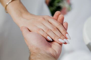 Newlyweds at the wedding romantic couple holding hands during destination wedding marriage...