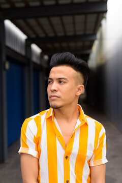 Young handsome multi ethnic man thinking outdoors
