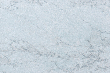 Texture of light blue marble with pattern, macro background. Pastel steel color stone backdrop from mineral tile.