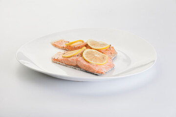 fish with lemon in a plate on a white background