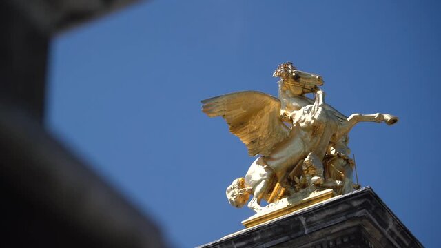 Golden Sculpture on the blue sky at a Bridge in Paris, France.  Beautiful dynamic composition.