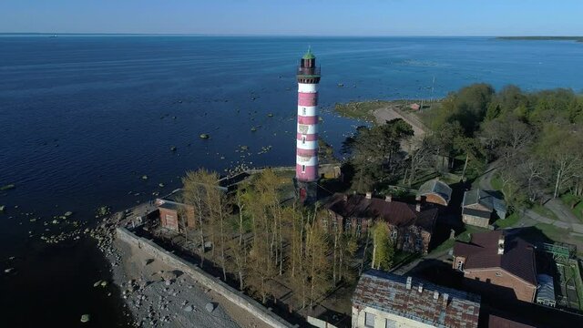 Old Shepelevsky lighthouse on the background of the Gulf of Finland on a may day (aerial video). Leningrad region, Russia 