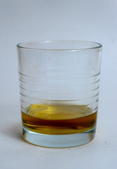 glass of whiskey with no ice on a white background