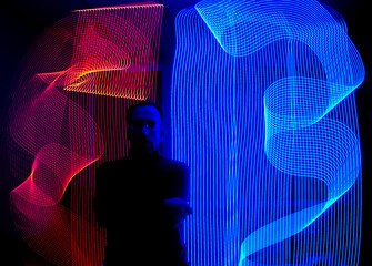 portrait of a man in avant-garde modern style on a dark background with illumination from light...