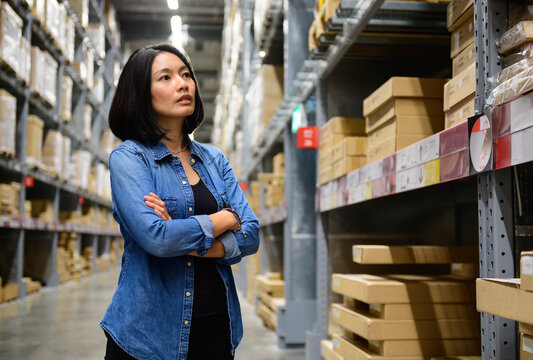 Portrait of female manager with arms crossed in warehouse