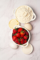 ingredients for baking strawberry muffins top view.