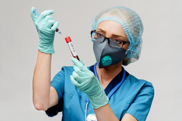medical doctor nurse woman wearing protective mask and gloves - holding virus blood test tube and...