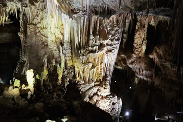 Beautiful colorful and illuminated cave with stalactites and stalagmites