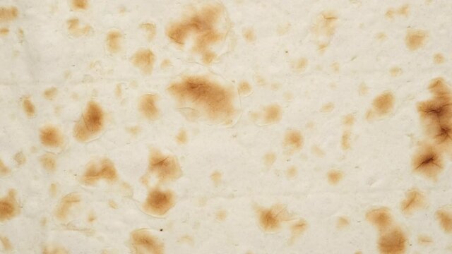 Armenian bread lavash rotating top view. Amazing macro background with vibrant texture