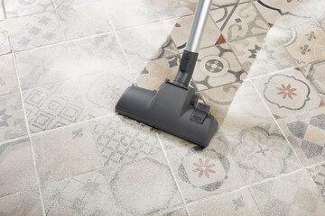 cleaning floor with modern vacuum cleaner in kitchen room. easy cleaning with vacuum cleaner