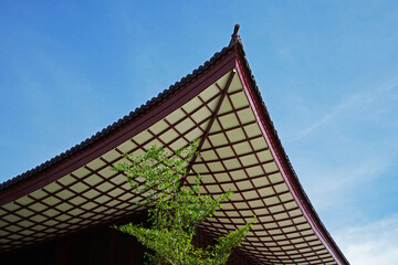 Exterior architecture and ceiling roof design of traditional Japanese castle building with clear blue sky built with wooden structure in oriental style