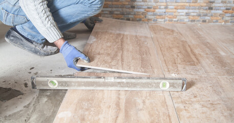 Laying floor ceramic tile. Renovating the floor