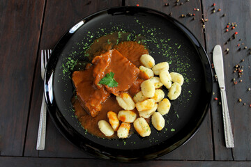 Pasticada with gnocchi, beef stew in a sauce. Croatian cuisine