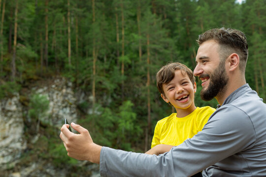 Father and son taking selfie. dad and child playing outdoor on summer vacation day