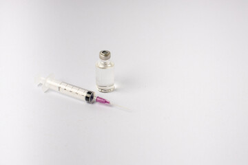syringe, vaccine, lying on a white background