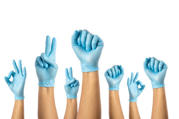 Obraz premium blue gloves for germs of medical personnel and the general public, raising their hands, raising their arms, joining forces