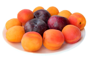 Naklejka na ściany i meble plate with fruit, apricots and plums on a white background