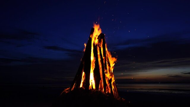 The big fire burns against the background of the night sky on the island of Zanzibar, Tanzania, East Africa, close up. Bright flame. A bonfire in the evening.