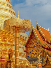 view of traditional golden umbrella lanna style art 13th. Century. with blue sky background, Wat Phra That Doi Suthep, Chiang mai, northern of Thailand.