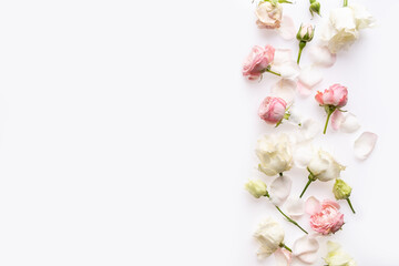 Naklejka premium Flowers composition. Rose flowers on white background. Flat lay, top view, copy space. Border frame.