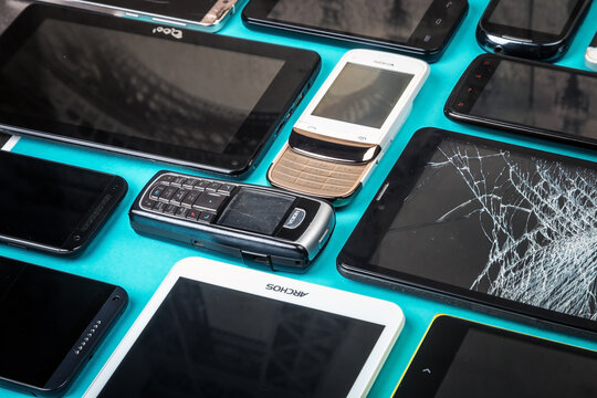Moscow, Russia-may 19, 2020: outdated and modern models of smartphones and mobile phones. Background of dirty, broken and old smartphones