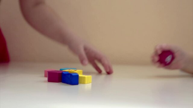 the child plays with wooden figures: shapes, numbers and colors. Details of the toy in the hands. Concept of development of fine motor skills, educational games, childhood, of, children's day, kinderg