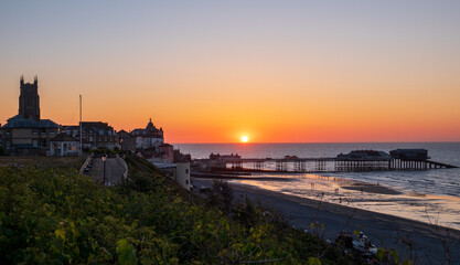 Cromer town and pier at sunset.