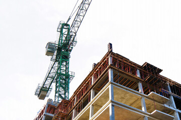 Building under construction. Construction site. Crane near building.