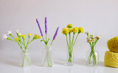 crochet handmade product for home decoration, dandelion, lavender, daisy flower in glass jar on white background