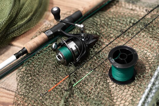 spin fishing rod with reel isolated. fishing line and net