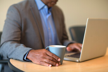 African American man at typing on a computer.