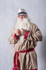 A grey-haired bearded old patriarch in bright national clothes is gesticulating emotionally against...