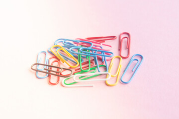 paper clips on a pastel background. The idea for the design of school notebooks.
