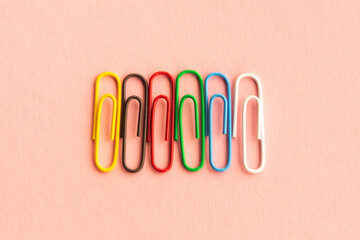 paper clips on a pastel background. The idea for the design of school notebooks.
