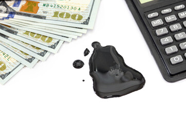 spilled crude naphtha and dollars, calculator on a white background. Oil crisis concept.