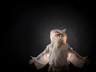 Portrait of a manly and brutal, majestic, old man, sorcerer, wizard with gray hair and a beard with...