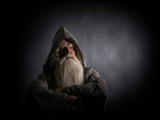 Portrait of a manly and brutal, majestic, old man, sorcerer, wizard with gray hair and a beard with...