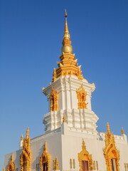 Naklejka premium view top of white Chedi (pagoda) Tian Yok with blue sky background, Wat Phumi Pharam, Chiang Rai, northern of Thailand.