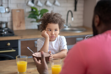 Cute little kid looking sad having no appetite