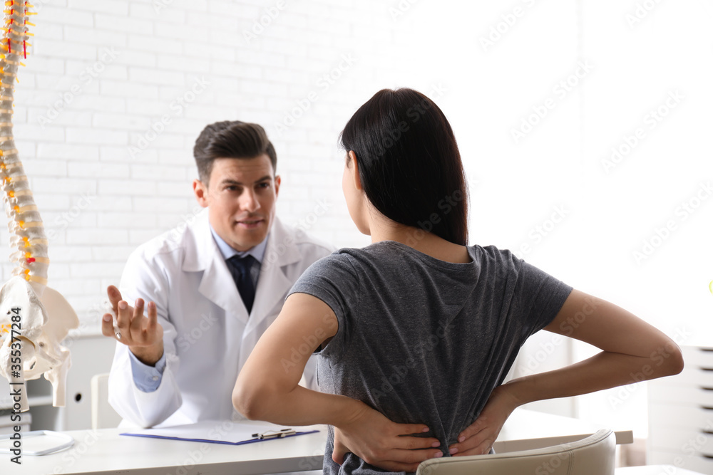 Poster young woman visiting orthopedist in medical office