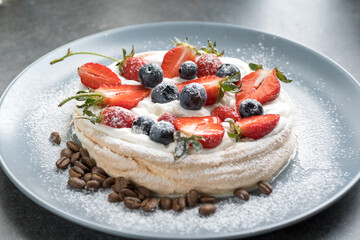 Pavlova dessert with berries. Pancakes with cream 