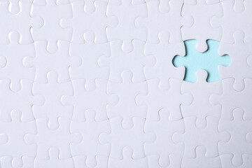 Blank white puzzle with missing piece on light blue background, top view. Space for text