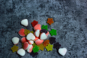 colorful candy with a variety of flavors in the photo with a cement-patterned background, the color of bright candy and fresh flavors arouse children's tastes,