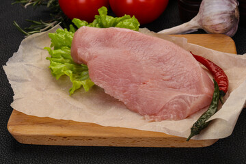 Raw Turkey steak served rosemary