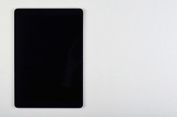 Portable tablet on grey background.
