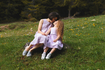 mother and daughter on stone