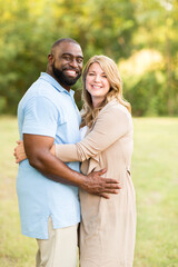 Obraz premium Loving mixed race couple hugging and laughing.