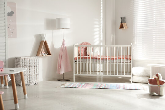 Cute Baby Room Interior With Crib And Decor Elements