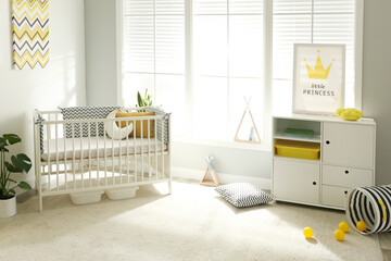 Cute baby room interior with crib and big window