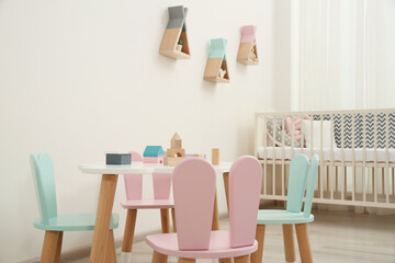 Cute baby room interior with cot and little table